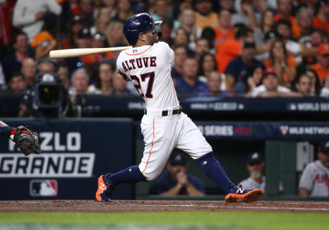 Nov 2, 2021; Houston, TX, USA; Houston Astros second baseman Jose Altuve hits an infield single against the Atlanta Braves during the first inning in game six of the 2021 World Series at Minute Maid Park. Mandatory Credit: Troy Taormina-USA TODAY Sports