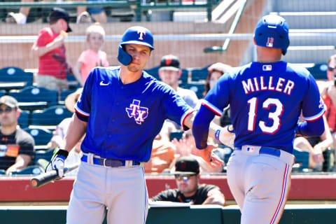 Apr 1, 2022; Scottsdale, Arizona, USA; Texas Rangers second baseman Brad Miller (13) celebrates with shortstop Corey Seager (5) after scoring in the first inning against the San Francisco Giants at Scottsdale Stadium. Mandatory Credit: Matt Kartozian-USA TODAY Sports