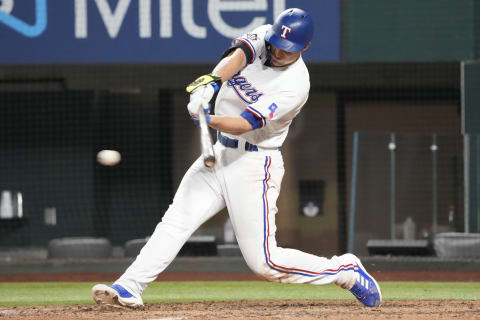 Apr 15, 2022; Arlington, Texas, USA; Texas Rangers shortstop Corey Seager singles against the Los Angeles Angels during the ninth inning of a baseball game at Globe Life Field. Mandatory Credit: Jim Cowsert-USA TODAY Sports