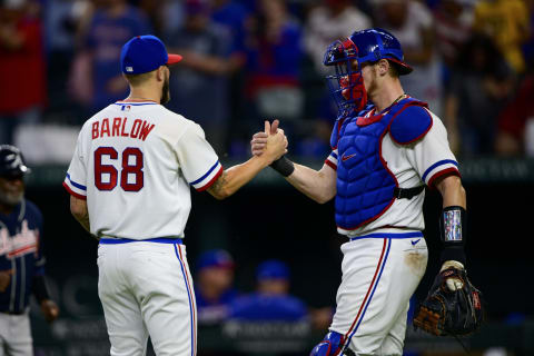 Apr 30, 2022; Arlington, Texas, USA; Texas Rangers relief pitcher Joe Barlow (68) and catcher Sam Huff (55) celebrate the win over the Atlanta Braves at Globe Life Field. Mandatory Credit: Jerome Miron-USA TODAY Sports