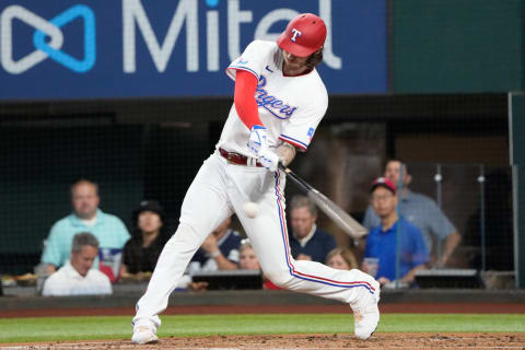 May 10, 2022; Arlington, Texas, USA; Texas Rangers catcher Jonah Heim (28) singles against the Kansas City Royals during the first inning at Globe Life Field. Mandatory Credit: Jim Cowsert-USA TODAY Sports