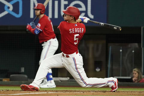 Jun 3, 2022; Arlington, Texas, USA; Texas Rangers shortstop Corey Seager (5) follows thru on an RBI double against the Seattle Mariners during the sixth inning at Globe Life Field. Mandatory Credit: Raymond Carlin III-USA TODAY Sports