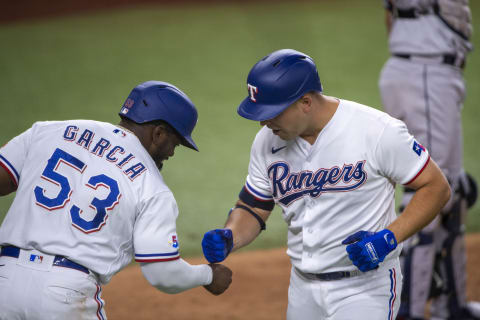 Jun 14, 2022; Arlington, Texas, USA; Texas Rangers first baseman Nathaniel Lowe (30) and right fielder Adolis Garcia (53) celebrate after Lowe hits a two run home run against the Houston Astros during the fourth inning at Globe Life Field. Mandatory Credit: Jerome Miron-USA TODAY Sports