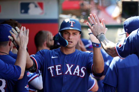 Oct 2, 2022; Anaheim, California, USA; Texas Rangers shortstop Corey Seager (5) is greeted in the dugout after hitting a home run during the fifth inning against the Los Angeles Angels at Angel Stadium. Mandatory Credit: Kiyoshi Mio-USA TODAY Sports