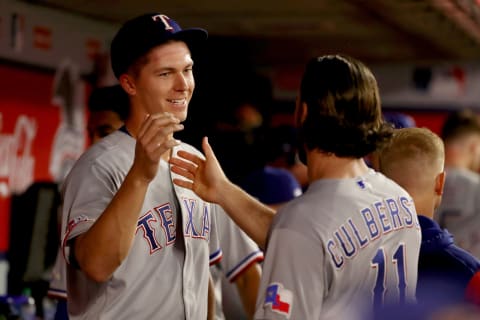 May 25, 2022; Anaheim, California, USA; Texas Rangers starting pitcher Glenn Otto (49) shakes hands with third baseman Charlie Culberson (11) in the fifth inning against the Los Angeles Angels at Angel Stadium. Mandatory Credit: Kiyoshi Mio-USA TODAY Sports