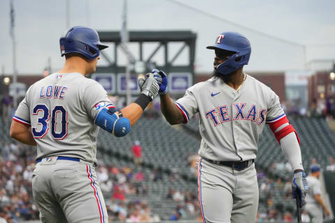 Aug 23, 2022; Denver, Colorado, USA; Texas Rangers first baseman Nathaniel Lowe (30) celebrates after hitting a two run home run with designated hitter Adolis Garcia (53) in the first inning against the Colorado Rockies at Coors Field. Mandatory Credit: Ron Chenoy-USA TODAY Sports