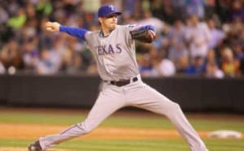 Jul 20, 2015; Denver, CO, USA; Texas Rangers relief pitcher Tanner Scheppers (52) delivers a pitch during the ninth inning against the Colorado Rockies at Coors Field. The Rockies won 8-7. Mandatory Credit: Chris Humphreys-USA TODAY Sports