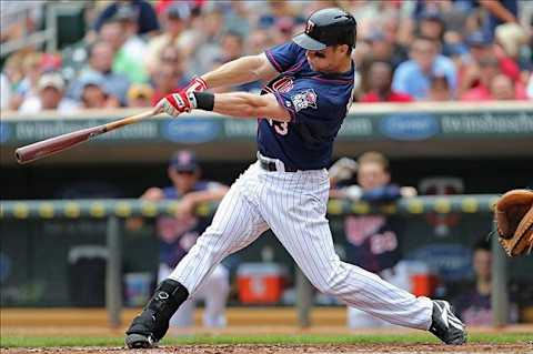 July 19, 2012; Minneapolis, MN, USA: Minnesota Twins first baseman Justin Morneau (33) hits a single in the fourth inning against the Baltimore Orioles at Target Field. The Orioles won 4-3. Mandatory Credit: Jesse Johnson-US PRESSWIRE