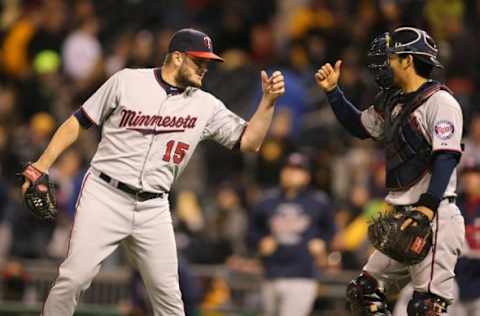 May 20, 2015; Pittsburgh, PA, USA; Minnesota Twins relief pitcher Glen Perkins (15) and Twins catcher Kurt Suzuki (8) celebrate after defeating the Pittsburgh Pirates in an inter-league game at PNC Park. The Twins won 4-3 in thirteen innings. Mandatory Credit: Charles LeClaire-USA TODAY Sports