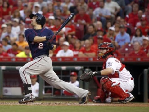 Jun 29, 2015; Cincinnati, OH, USA; Minnesota Twins second baseman Brian Dozier (2) hits a three-run home run in the fourth inning against the Cincinnati Reds at Great American Ball Park. Reds catcher Tucker Barnhart watches at right. Mandatory Credit: David Kohl-USA TODAY Sports