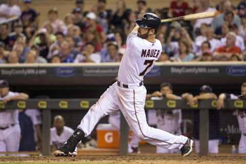 Aug 11, 2015; Minneapolis, MN, USA; Minnesota Twins first baseman Joe Mauer (7) hits a RBI double in eighth inning against the Texas Rangers at Target Field. The Twins won 3-2. Mandatory Credit: Jesse Johnson-USA TODAY Sports