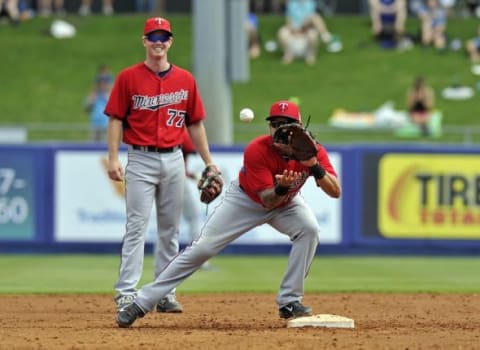 Mar 15, 2014; Port St. Lucie, FL, USA; Minnesota Twins shortstop Jason Bartlett (right) warms up as teammate James Beresford (left) looks on before a game against the New York Mets at Tradition Stadium. Mandatory Credit: Steve Mitchell-USA TODAY Sports