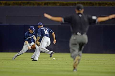 Sep 29, 2015; San Diego, CA, USA; Milwaukee Brewers second baseman Scooter Gennett (left) and right fielder Domingo Santana (16) cannot get to a ball hit by San Diego Padres catcher Austin Hedges (not pictured) during the second inning at Petco Park. Mandatory Credit: Jake Roth-USA TODAY Sports