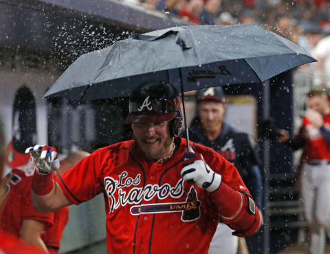 ATLANTA, GEORGIA – SEPTEMBER 06: Third baseman Josh Donaldson #20 of the Atlanta Braves celebrates in the dugout with an umbrella after hitting a 2-run home run in the seventh inning during the game against the Washington Nationals at SunTrust Park on September 06, 2019 in Atlanta, Georgia. (Photo by Mike Zarrilli/Getty Images)