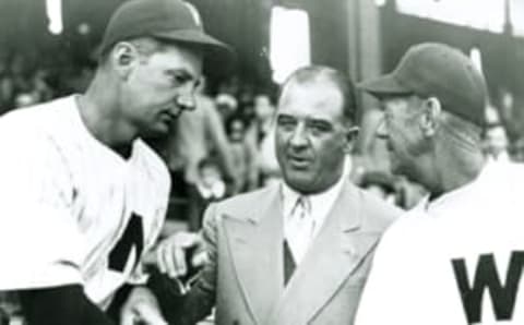 Happy Chandler, commissioner of Major League Baseball, talks with Joe Kuhel, left, and Joe Fitzgerald of Washington Senators (Photo Reproduction by Transcendental Graphics/Getty Images)