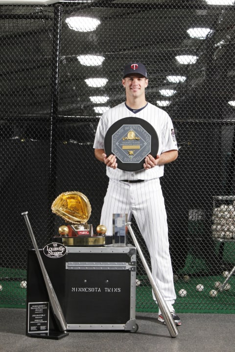 Joe Mauer of the Minnesota Twins poses with his 2009 AL MVP Award, 2009 Silver Slugger Award, 2009 AL Batting Champion Award, 2009 MLB Players’ Choice Award, and 2009 Golden Glove Award (Photo by Bruce Kluckhohn/Getty Images)