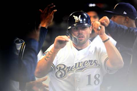 MILWAUKEE, WI – OCTOBER 19: Mike Moustakas #18 of the Milwaukee Brewers celebrates with his teammates after scoring a run off of a single hit by Erik Kratz #15 against Hyun-Jin Ryu #99 of the Los Angeles Dodgers during the first inning in Game Six of the National League Championship Series at Miller Park on October 19, 2018 in Milwaukee, Wisconsin. (Photo by Stacy Revere/Getty Images)