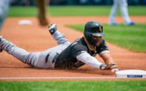 Yoan Moncada of the Chicago White Sox slides into third, beating the tag. (Photo by Kyle Rivas/Getty Images)