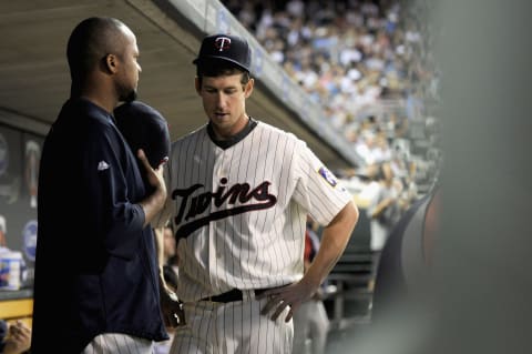 Francisco Liriano and Kevin Slowey of the Minnesota Twins speak in the dugout during the game against the New York Yankees on August 19, 2011 at Target Field in Minneapolis, Minnesota. (Photo by Hannah Foslien/Getty Images)