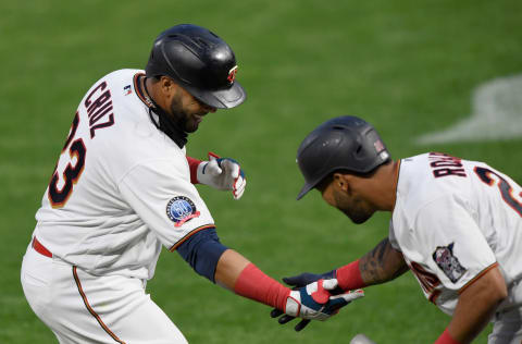 Eddie Rosario congratulates Minnesota Twins teammate Nelson Cruz on a solo home run against the Kansas City Royals. (Photo by Hannah Foslien/Getty Images)