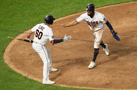 Jake Cave of the Minnesota Twins congratulates teammate Byron Buxton on scoring the walk-off run against the Milwaukee Brewers. (Photo by Hannah Foslien/Getty Images)