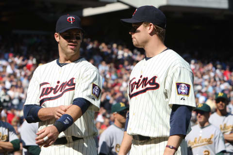 Joe Mauer and Justin Morneau of the Minnesota Twins are introduced prior to the game against the Oakland Athletics on April 8, 2011 at the Target Field in Minneapolis, Minnesota. The Twins defeated the Athletics 2-1. (Photo by Brace Hemmelgarn/Minnesota Twins/Getty Images)