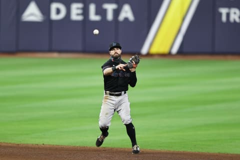 Jon Berti of the Miami Marlins fields a ball to first. (Photo by Elsa/Getty Images)