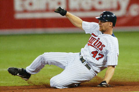 Third baseman Corey Koskie of the Minnesota Twins slides during game three. (Photo by Jonathan Daniel/Getty Images)