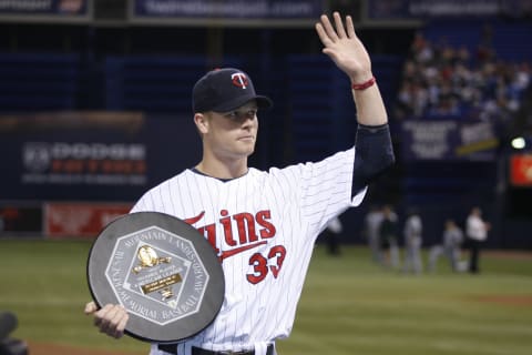 Justin Morneau of the Minnesota Twins acknowledges the crowd with his 2006 American League Most Valuable Player Award. (Photo by Bruce Kluckhohn/MLB Photos via Getty Images)