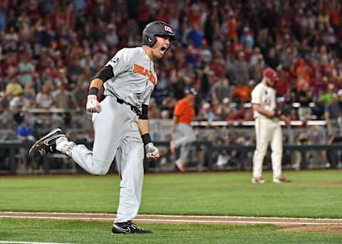 Omaha, NE – JUNE 27: Outfielder Trevor Larnach #11 of the Oregon State Beavers reacts after hitting a two run home run to give the Beavers a 5-3 lead in the ninth inning against the Arkansas Razorbacks during game two of the College World Series Championship Series on June 27, 2018 at TD Ameritrade Park in Omaha, Nebraska. (Photo by Peter Aiken/Getty Images)