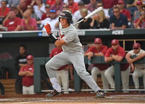 Omaha, NE – JUNE 28: Catcher Adley Rutschman #35 of the Oregon State Beavers singes in a run in the first inning against the Arkansas Razorbacks during game three of the College World Series Championship Series on June 28, 2018 at TD Ameritrade Park in Omaha, Nebraska. (Photo by Peter Aiken/Getty Images)