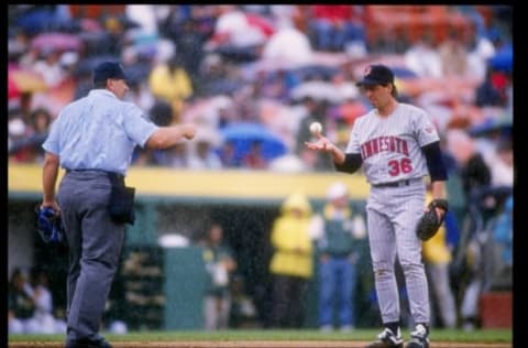 26 May 1993: An official confers with pitcher Kevin Tapani of the Minnesota Twins during a game against the Oakland Athletics at the Oakland-Alameda County Coliseum in Oakland, California.