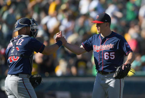 OAKLAND, CA – SEPTEMBER 23: Trevor May #65 and Chris Gimenez #46 of the Minnesota Twins celebrates defeating the Oakland Athletics 5-1 at Oakland Alameda Coliseum on September 23, 2018 in Oakland, California. (Photo by Thearon W. Henderson/Getty Images)