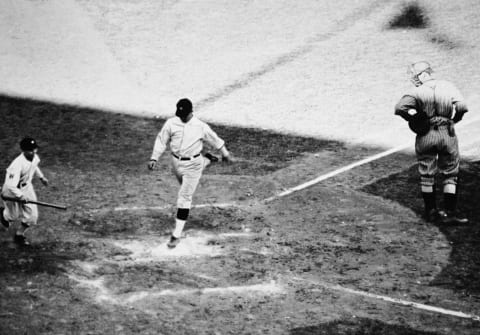 American baseball player Stanley “Bucky” Harris (1896- 1977), playing for the Washington Senators, lands on home plate after scoring a homerun during the seventh game of the World Series at Griffith Stadium, Washington, D.C., October 10, 1924. Washington won the game and the series. (Photo by Credit: APA/Getty Images)