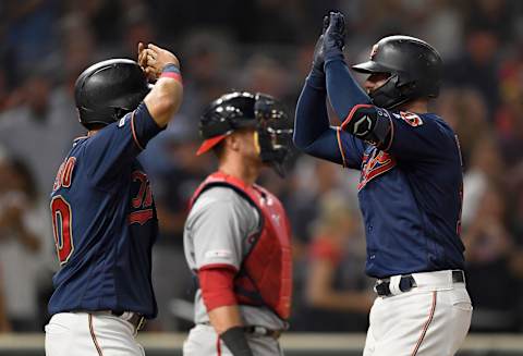 MINNEAPOLIS, MINNESOTA – SEPTEMBER 10: Eddie Rosario #20 of the Minnesota Twins congratulates teammate Mitch Garver #18 on a two-run home run as Yan Gomes #10 of the Washington Nationals looks on during the seventh inning of the interleague game at Target Field on September 10, 2019 in Minneapolis, Minnesota. The Twins defeated the Nationals 5-0. (Photo by Hannah Foslien/Getty Images)