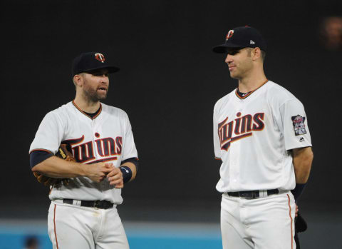 Minnesota Twins second baseman Brian Dozier and first baseman Joe Mauer wait as a new pitcher warms up during the ninth inning. (Marilyn Indahl-USA TODAY Sports)