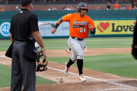 Minnesota Twins prospect Christian Encarnacion-Strand runs home to score a run while playing at Oklahoma State.