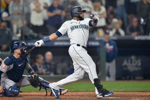 Seattle Mariners designated hitter Carlos Santana hits a single in the seventeenth inning against the Houston Astros. (Steven Bisig-USA TODAY Sports)