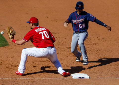 Mar 3, 2017; Clearwater, FL, USA; Minnesota Twins base runner Zach Granite (66) beats the throw to Philadelphia Phillies first baseman Rhys Hoskins (70) as he gets back to the bag in the seventh inning of a baseball game during spring training at Spectrum Field. Mandatory Credit: Butch Dill-USA TODAY Sports