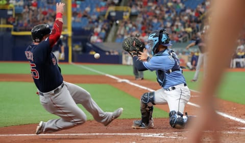 Michael Perez making a play at the plate. (Photo by Mike Carlson/Getty Images)