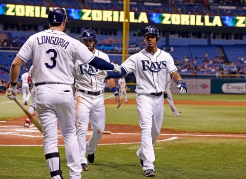 Evan Longoria #3 of the Tampa Bay Rays congratulates Sean Rodriguez #1 and Desmond Jennings #8 Tropicana Field on September 18, 2012 (Photo by J. Meric/Getty Images)