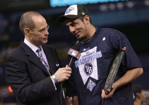 ST PETERSBURG, FL – OCTOBER 19: Television personality Ernie Johnson talks with pitcher Matt Garza #22 of the Tampa Bay Rays after defeating the Boston Red Sox in game seven of the American League Championship Series during the 2008 MLB playoffs on October 19, 2008 at Tropicana Field in St Petersburg, Florida. The Rays defeated the Red Sox 3-1 to win the series 4-3. (Photo by Doug Pensinger/Getty Images)