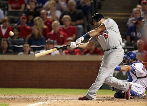 Oct 22, 2011; Arlington, TX, USA; St. Louis Cardinals first baseman Albert Pujols hits a solo home run in the ninth inning of game three of the 2011 World Series against the Texas Rangers at Rangers Ballpark. The Cardinals won 16-7. Mandatory Credit: Matthew Emmons-US PRESSWIRE