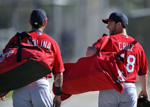 Feb 15, 2014; Jupiter, FL, USA; St. Louis Cardinals catcher Tony Cruz (right) chats with teammate catcher Yadier Molina (left) during spring training at Roger Dean Stadium. Mandatory Credit: Steve Mitchell-USA TODAY Sports