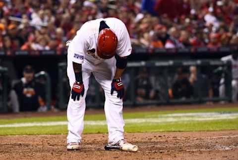 Oct 12, 2014; St. Louis, MO, USA; St. Louis Cardinals catcher Yadier Molina (4) reacts as he grounds into a double play against the San Francisco Giants in the sixth inning in game two of the 2014 NLCS playoff baseball game at Busch Stadium. Molina suffered an apparent injury on the swing and had to be helped off the field. Image Credit: Jasen Vinlove-USA TODAY Sports