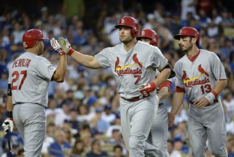 Oct 3, 2014; Los Angeles, CA, USA; St. Louis Cardinals left fielder Matt Holliday (7) is congratulated after he hits a three run home run in the seventh inning against the Los Angeles Dodgers in game one of the 2014 NLDS playoff baseball game at Dodger Stadium. Mandatory Credit: Richard Mackson-USA TODAY Sports