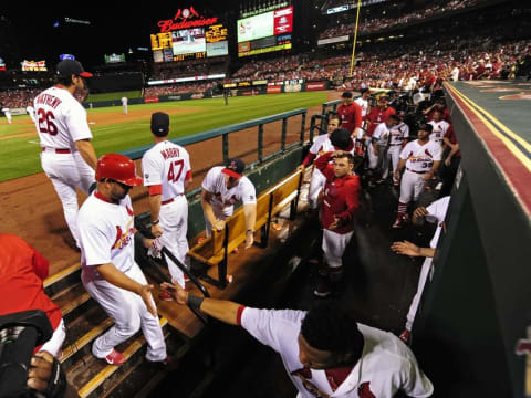 Jun 28, 2015; St. Louis, MO, USA; St. Louis Cardinals shortstop Jhonny Peralta (27) is congratulated by teammates after scoring against the Chicago Cubs during the fourth inning at Busch Stadium. Mandatory Credit: Jeff Curry-USA TODAY Sports