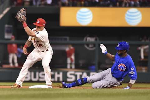 Oct 10, 2015; St. Louis, MO, USA; Chicago Cubs center fielder Dexter Fowler (right) slides into second base on a double against St. Louis Cardinals second baseman Kolten Wong (16) during the seventh inning in game two of the NLDS at Busch Stadium. Mandatory Credit: Jasen Vinlove-USA TODAY Sports