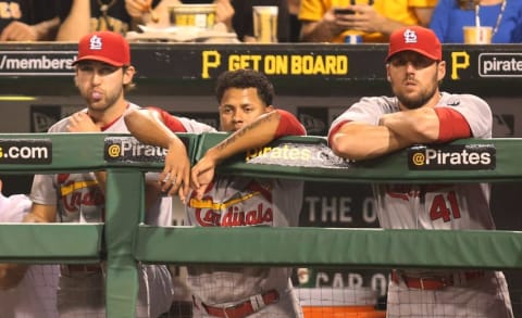 May 9, 2015; Pittsburgh, PA, USA; St. Louis Cardinals pitchers Michael Wacha (L) and starting pitcher Carlos Martinez (C) and John Lackey (R) look on over the dugout rail against the Pittsburgh Pirates during the sixth inning at PNC Park. The Pirates won 7-5. Mandatory Credit: Charles LeClaire-USA TODAY Sports