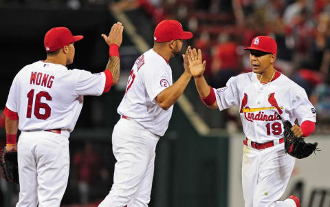 Apr 17, 2015; St. Louis, MO, USA; St. Louis Cardinals center fielder Jon Jay (19) celebrates with shortstop Jhonny Peralta (27) and second baseman Kolten Wong (16) after defeating the Cincinnati Reds 6-1 at Busch Stadium. Mandatory Credit: Jeff Curry-USA TODAY Sports